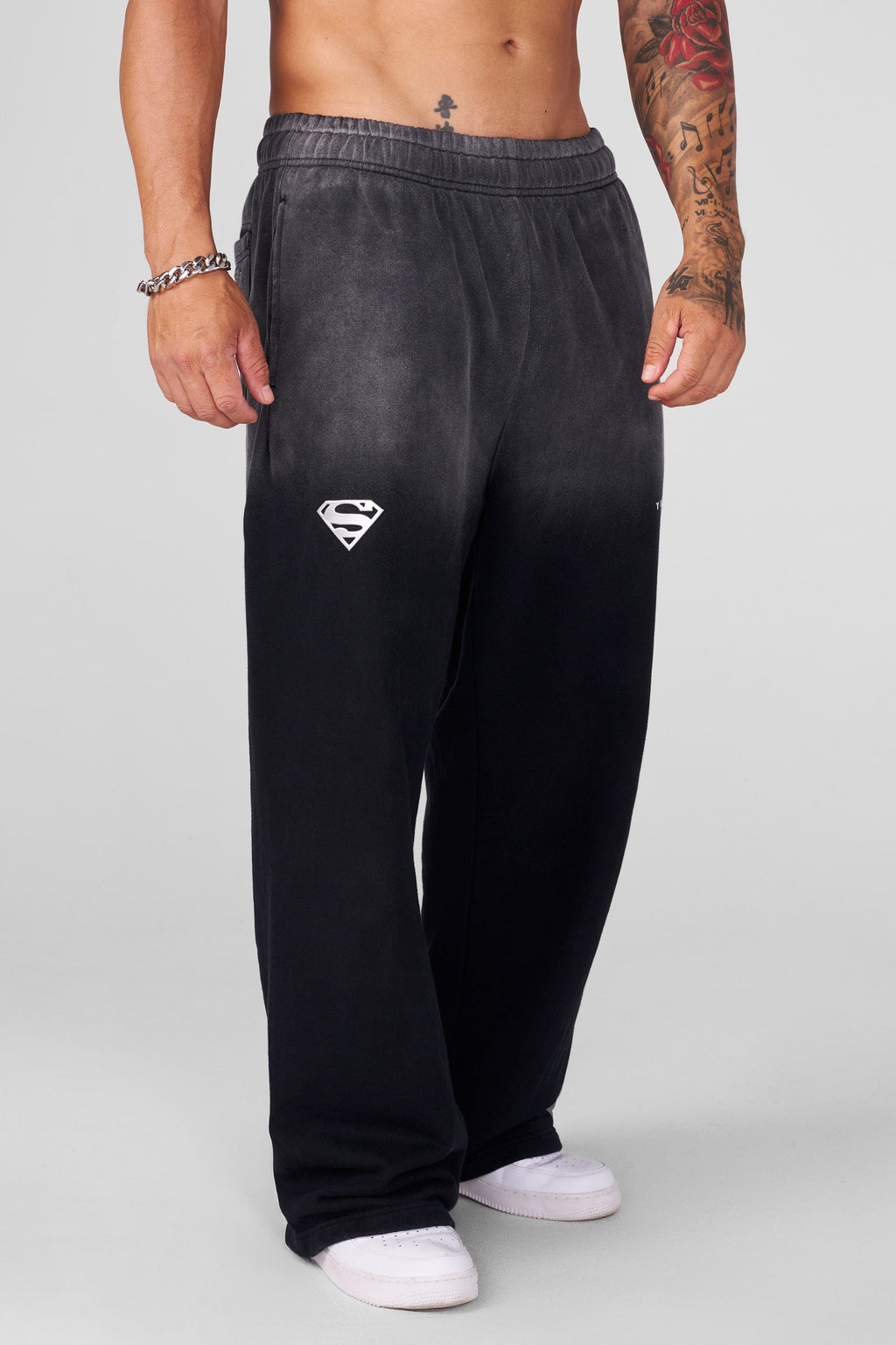 2032 - Superman Sweats - Man of Steel sweatpants from Superman x YoungLA collaboration, acid-wash design, YoungLA chrome logo on left leg, Superman logo on right, baggy fit for comfortable everyday wear in Black Wash